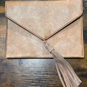 Women’s tan clutch with tassel